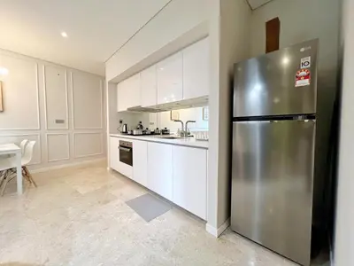 a large kitchen with a stainless steel refrigerator at Sky Suites Unique 3BR Suite KLCC View in Kuala Lumpur
