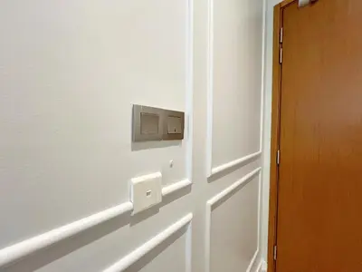 a door with a light switch on a wall at Sky Suites Unique 3BR Suite KLCC View in Kuala Lumpur