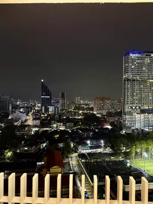 a city skyline at night with a tall building at Klcc view residences in Kuala Lumpur