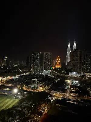 a city lit up at night with buildings at Klcc view residences in Kuala Lumpur