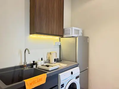 a small kitchen with a sink and a refrigerator at X - The Thomas Bangsar South Midvalley LRT Kerinchi in Kuala Lumpur
