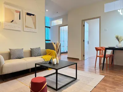 a living room with a couch and a table at X - The Thomas Bangsar South Midvalley LRT Kerinchi in Kuala Lumpur