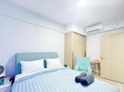 a bedroom with a blue bed and a blue chair at KIcc view residences by the colony in Kuala Lumpur