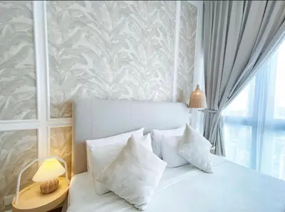 a bedroom with a white bed with pillows and a window at KIcc view residences by the colony in Kuala Lumpur