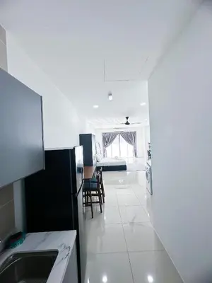 a white kitchen with a table and a chair at The Nest Residensi 357 Jalan Genting Kelang, Setapak KL by Idealhub in Kuala Lumpur