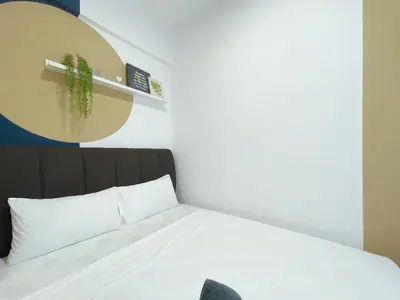a bedroom with a bed with a cactus on a shelf at The colony by infinitum sweet home in Kuala Lumpur
