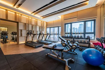a gym with cardio equipment and a large window at Agile Premier Suites Kuala Lumpur in Kuala Lumpur