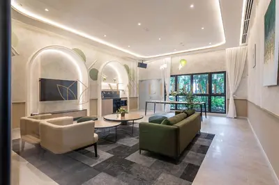 a living room with a couch and chairs and a table at Agile Premier Suites Kuala Lumpur in Kuala Lumpur