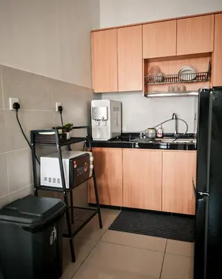 a small kitchen with a sink and a refrigerator at MH Platinum 2 Homestay 3Bedroom in Kuala Lumpur