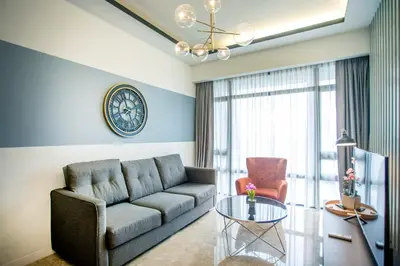 a living room with a couch and a glass table at Anggun Residence near KLCC in Kuala Lumpur