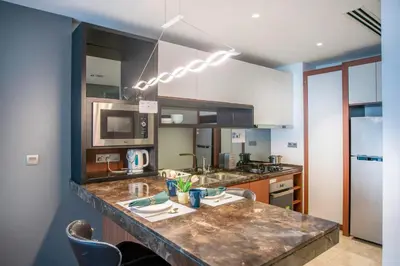 a kitchen with a large marble counter top at Anggun Residence near KLCC in Kuala Lumpur