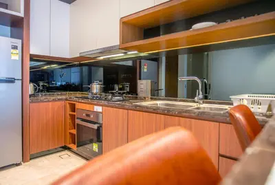 a large kitchen with a sink and a stove at Anggun Residence near KLCC in Kuala Lumpur
