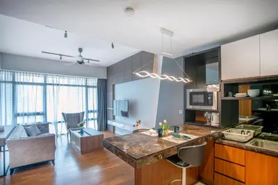 a kitchen and living room with a large counter top at Anggun Residence near KLCC in Kuala Lumpur