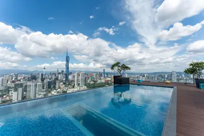 a swimming pool on top of a building with a city at The Riv at Riveria City KL Sentral by Luxe n Comfy in Kuala Lumpur