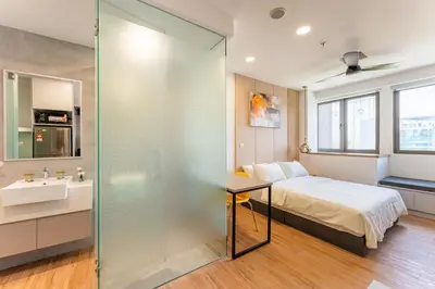 a bedroom with a bed and a sink and a mirror at The Riv at Riveria City KL Sentral by Luxe n Comfy in Kuala Lumpur