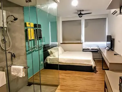a bedroom with a bed and a glass shower at The Riv at Riveria City KL Sentral by Luxe n Comfy in Kuala Lumpur