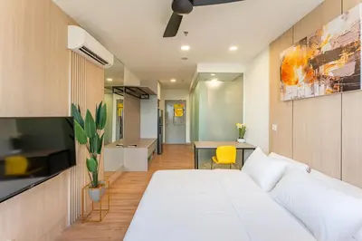 a bedroom with a white bed and a table at The Riv at Riveria City KL Sentral by Luxe n Comfy in Kuala Lumpur