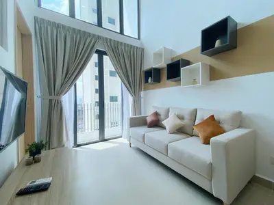 a living room with a couch and a large window at The Colony Infinitum By Happy Stay in Kuala Lumpur