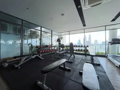 a gym with a view of a city at The Colony Infinitum By Happy Stay in Kuala Lumpur