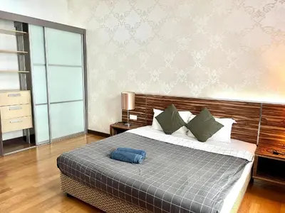 a bedroom with a bed with a blue pillow on it at Regalia residency in Kuala Lumpur