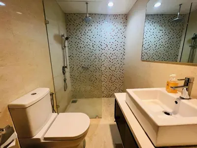 a bathroom with a toilet and a sink and a shower at Regalia residency in Kuala Lumpur