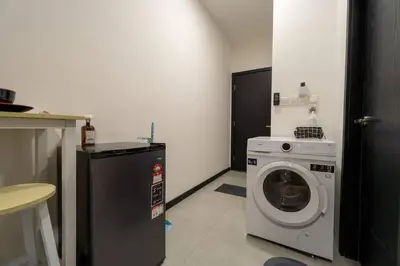 a laundry room with a washing machine and a washer at Neu Suites By Cozy Unit L30RA 2-3PAX near KLCC & Jelatek LRT in Kuala Lumpur