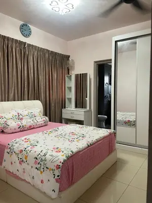 a bedroom with a bed and a dresser and a mirror at Azmaya homestay in Kuala Lumpur