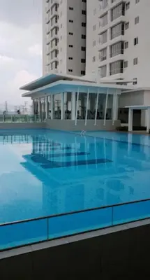 a large swimming pool in front of a building at Azmaya homestay in Kuala Lumpur