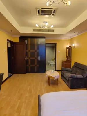 a room with a bed and a couch and a table at Penthouse Duplex with KLCC Views At Times Square in Kuala Lumpur