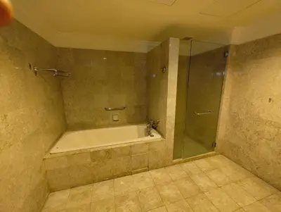 a bathroom with a bath tub and a shower at Penthouse Duplex with KLCC Views At Times Square in Kuala Lumpur