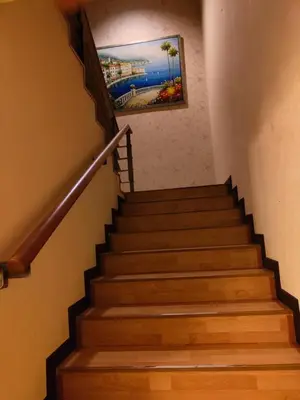 a set of stairs with a painting on the wall at Penthouse Duplex with KLCC Views At Times Square in Kuala Lumpur