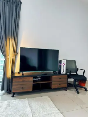 a living room with a large flat screen tv at Razak City Residences in Kuala Lumpur