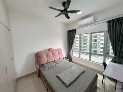 a bedroom with a pink chair and a window at Razak City Residences in Kuala Lumpur