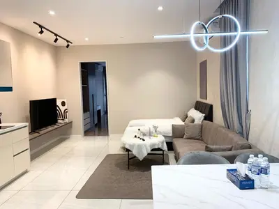 a living room with a couch and a tv at Quill Residences Service Suites By BR in Kuala Lumpur