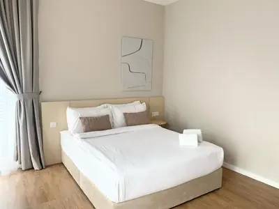 a bedroom with a white bed and a window at Quill Residences Service Suites By BR in Kuala Lumpur