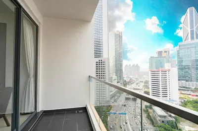 a balcony with a view of a city at Spacious Family Apt 3-Min Walk to KLCC MRT RO Water Baby Crib Home Cinema Projector in Kuala Lumpur