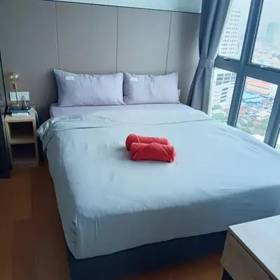 a large bed with a red towel on it at The luxe suite service KLCC in Kuala Lumpur