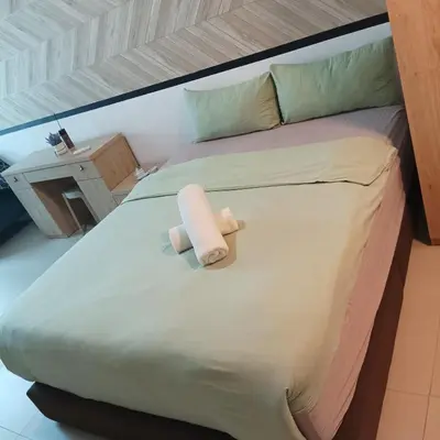 a bed with a towel sitting on top of it at The luxe suite service KLCC in Kuala Lumpur