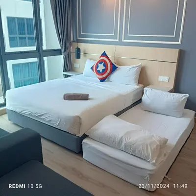 two beds in a hotel room with a pillow on them at The luxe suite service KLCC in Kuala Lumpur