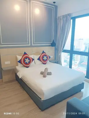 a bedroom with a bed with two teddy bears on it at The luxe suite service KLCC in Kuala Lumpur