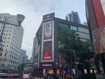 a building with a sign on it in a city at Hotel grand orchard in Kuala Lumpur