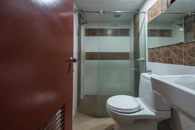 a bathroom with a toilet and a shower and a sink at Hotel grand orchard in Kuala Lumpur
