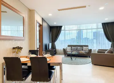 a dining room with a table and a living room at Vortex KLCC Vibes in Kuala Lumpur