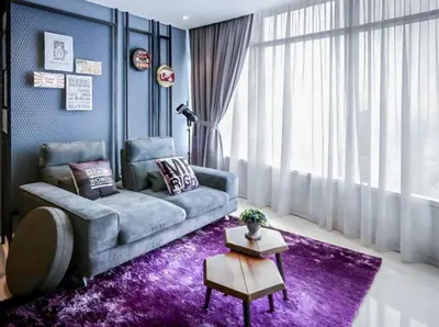 a living room with a couch and a purple rug at Vortex KLCC Vibes in Kuala Lumpur