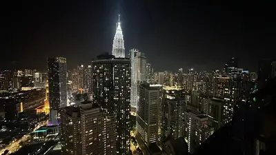 a view of a large city at night at Vortex KLCC Vibes in Kuala Lumpur