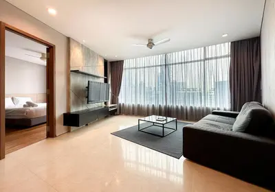 a living room with a couch and a large window at Vortex KLCC Vibes in Kuala Lumpur