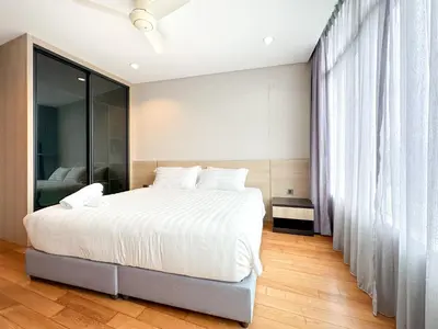 a bedroom with a large white bed and a window at Vortex KLCC Vibes in Kuala Lumpur