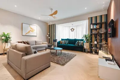 a living room with a couch and a blue sofa at Retreat In The Heart of KLCC, The Corinthians in Kuala Lumpur