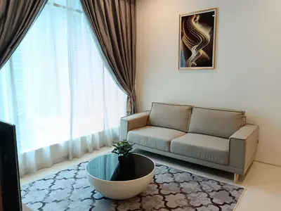 a living room with a couch and a table at Soho Suites KLCC by Minsha Homes in Kuala Lumpur