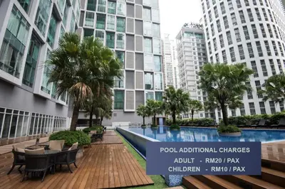 a swimming pool in a building with tall buildings at Soho Suites KLCC by Minsha Homes in Kuala Lumpur